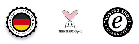 Drei weiße Buttons mit "Made in Germany", "Tierversuchsfrei" und "Trusted Shops Guarantee"